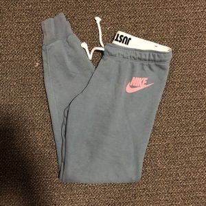 Gray Nike joggers with pink logo